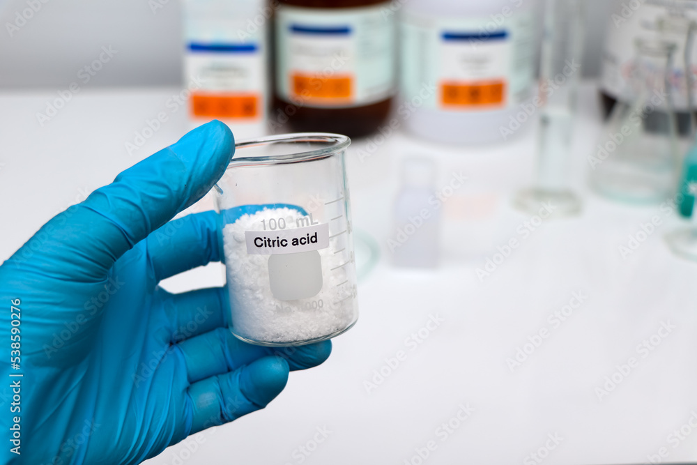 Citric acid in glass, chemical in the laboratory and industry Citric acid in glass, chemical in the laboratory and industry