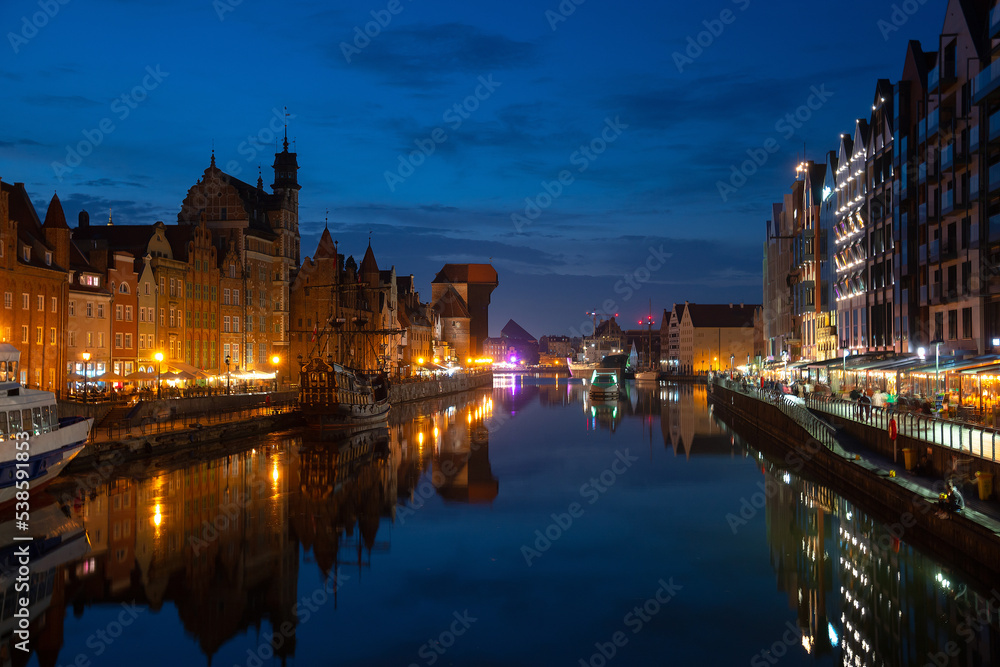 Fototapeta premium Scenic summer evening panorama of the architectural embankment pier canal river illumination of the Old Town GDANSK, POLAND