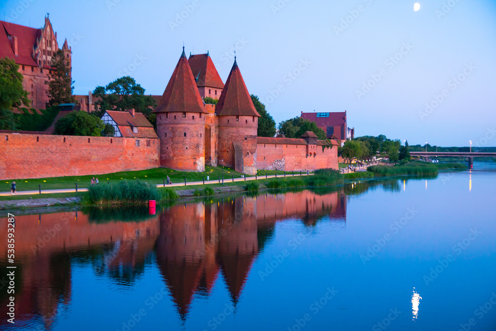 Marienburg castle the largest medieval brick castle in the world in the city of Malbork evening view at night Marienburg castle the largest medieval brick castle in the world in the city of Malbork evening view at night