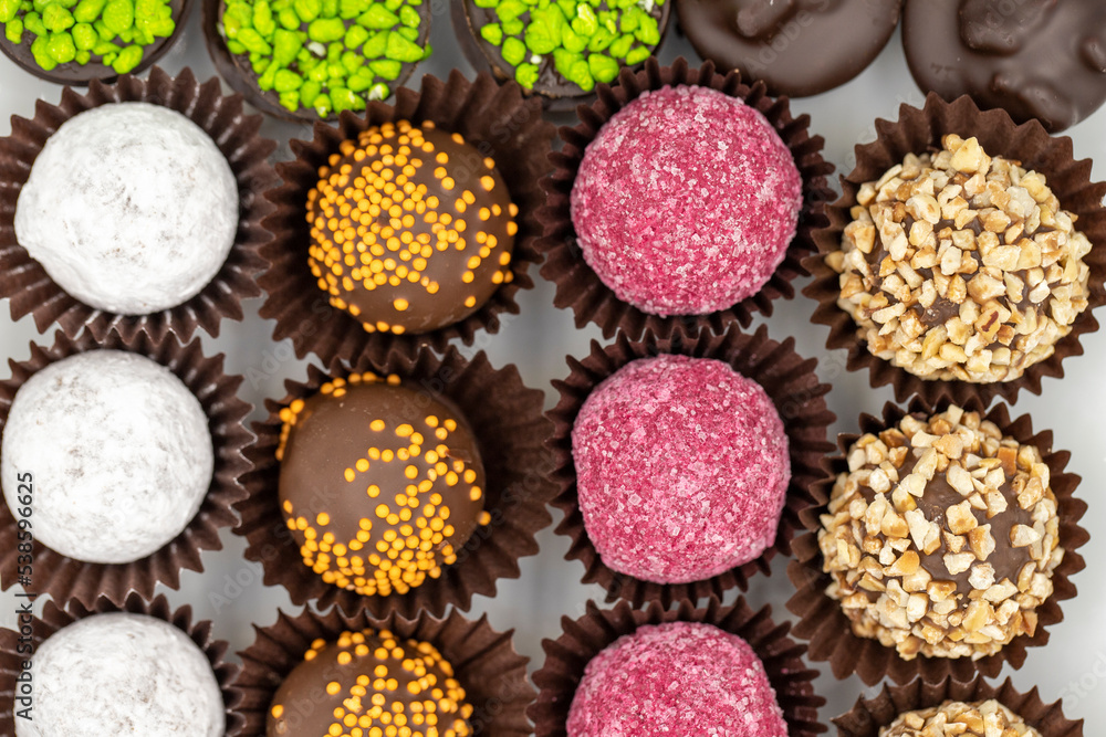 Chocolate praline. Assortment of chocolates on a white background. Top view Chocolate praline. Assortment of chocolates on a white background. Top view