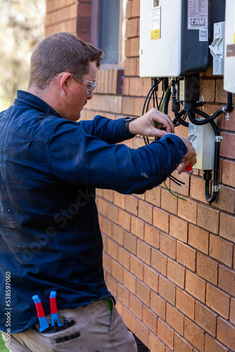 Wallpaper Mural Electrician working on installing a solar power board Torontodigital.ca