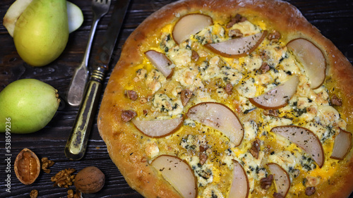 Homemade pizza with pear and walnuts. Dorblu pizza.
