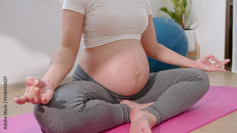 Asian Pregnant Woman deep breath with fresh air do yoga lotus pose comfortable at home. Asian Pregnant Woman deep breath with fresh air do yoga lotus pose comfortable at home.
