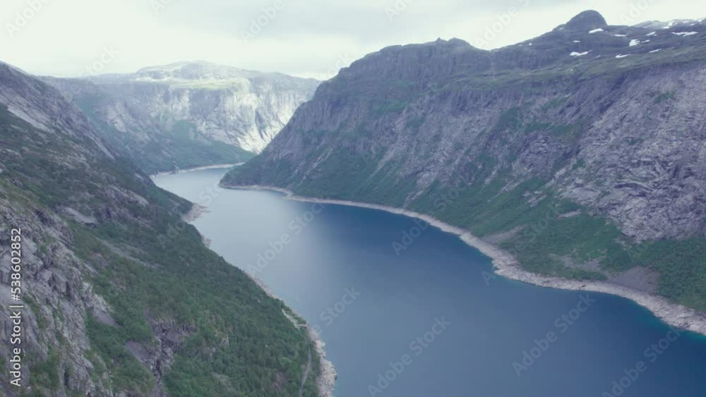 drone flies through clouds, aerial view of fjord and waterfall drone flies through clouds, aerial view of fjord and waterfall