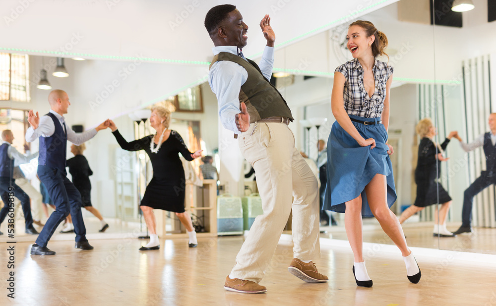 Fototapeta premium Woman and man dancing swing in studio