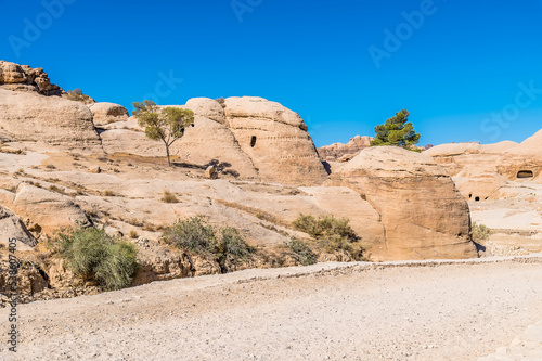 A view of the low hillside beside the path leading to the ancient city of Petra, Jordan in summertime