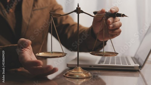 law books and scales of justice on desk in library of law firm. jurisprudence legal education concept.