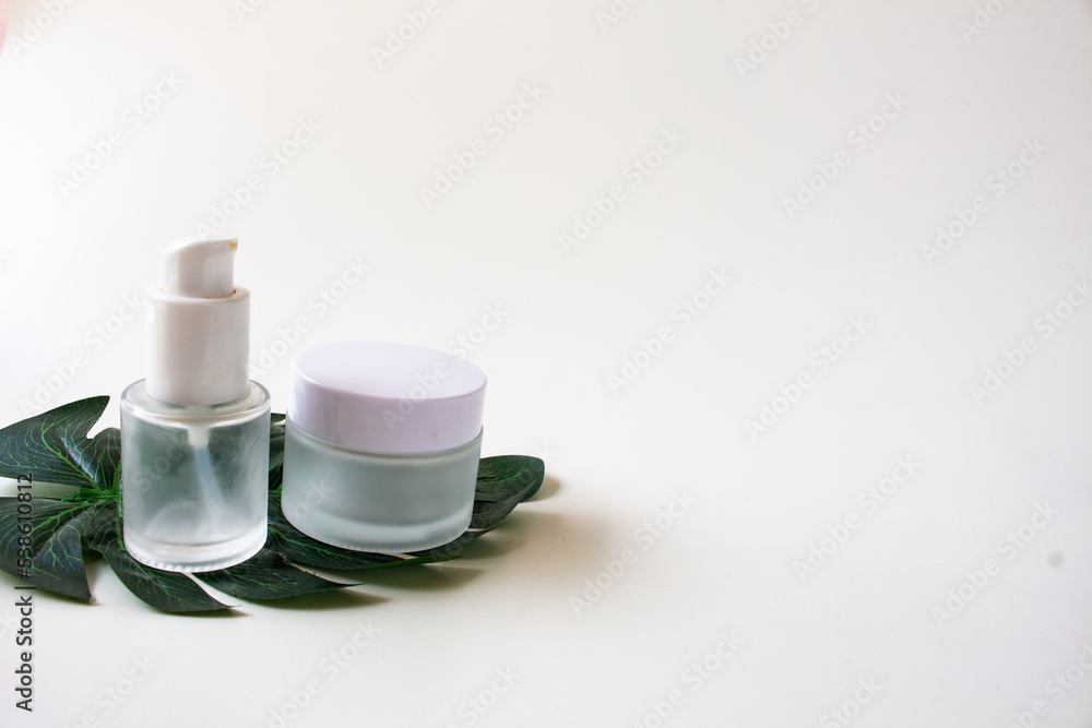 White Skincare Bottle and Jar with Leaf. Organic Natural Beauty Product. Herbal Alternative Medicine. Beauty Cosmetic. White Skincare Bottle and Jar with Leaf. Organic Natural Beauty Product. Herbal Alternative Medicine. Beauty Cosmetic.