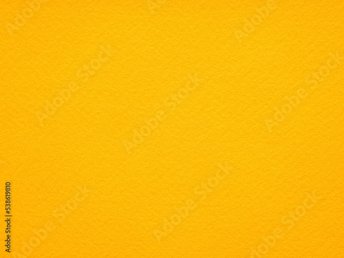 Photo of an orange, yellow texture of felt fabric. Soft orange background for text or lettering. Natural felt. Full frame background texture pattern of art and stationery material in magenta color.