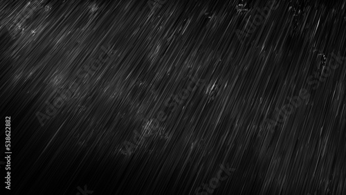 黒い背景に雨が降る画像