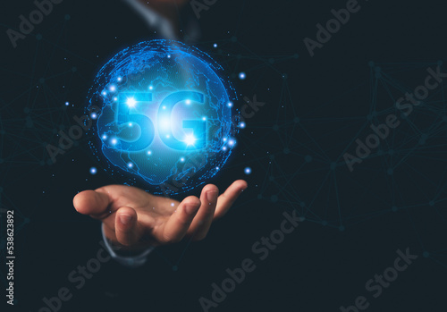 businessman holding a smartphone with hologram 5G digital technology. 5G wireless internet network concept or IOT  high-speed communication connection.