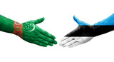 Handshake between Estonia and Turkmenistan flags painted on hands, isolated transparent image.
