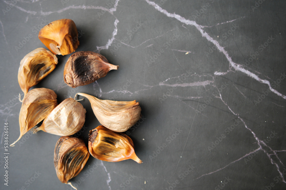 close up pf black garlic on white background table close up pf black garlic on white background table
