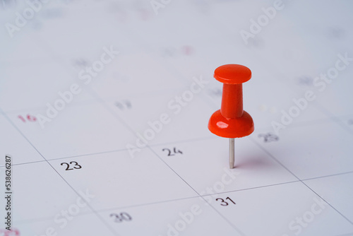 Red pin on calendar for business meeting and travel planing concept.