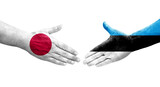 Handshake between Estonia and Japan flags painted on hands, isolated transparent image.