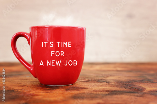 Coffee cup over on wooden table with the text – it's time for a new job