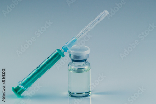 close up of glass medicine vial with syringe and needle isolated on white background. flu vaccine, doping in sport or botox hualuronic collagen