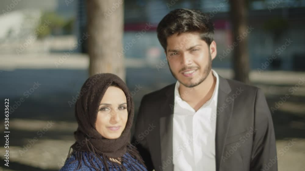 Happy muslim couple looking affectionately at each other and smiling. Young man in black suit, pretty woman in hijab being happy. Muslim family and relationships concept Happy muslim couple looking affectionately at each other and smiling. Young man in black suit, pretty woman in hijab being happy. Muslim family and relationships concept