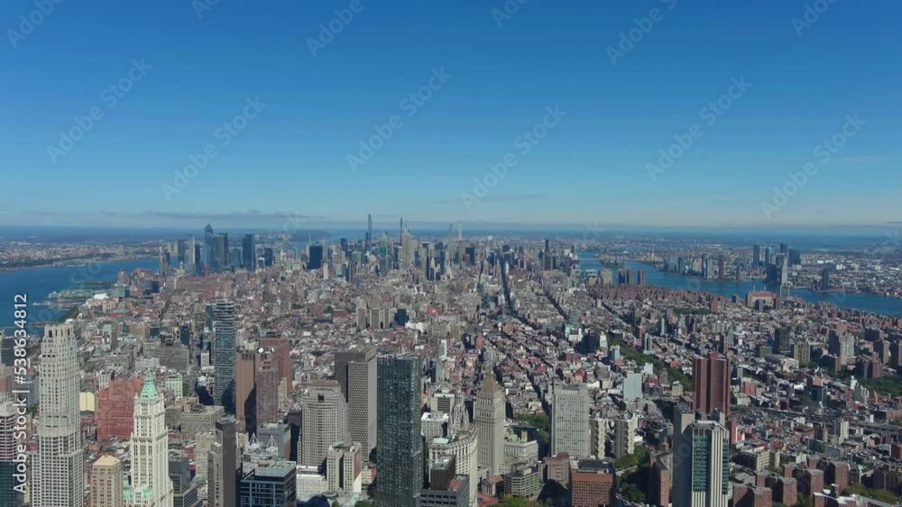 Manhattan midtown view, clear blue sky. Camera slowly goes down towards financial district and Brooklyn Bridge entrance, New York. Manhattan midtown view, clear blue sky. Camera slowly goes down towards financial district and Brooklyn Bridge entrance, New York.