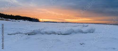 orange sunset on the snowy seashore © Dmitriy Popov