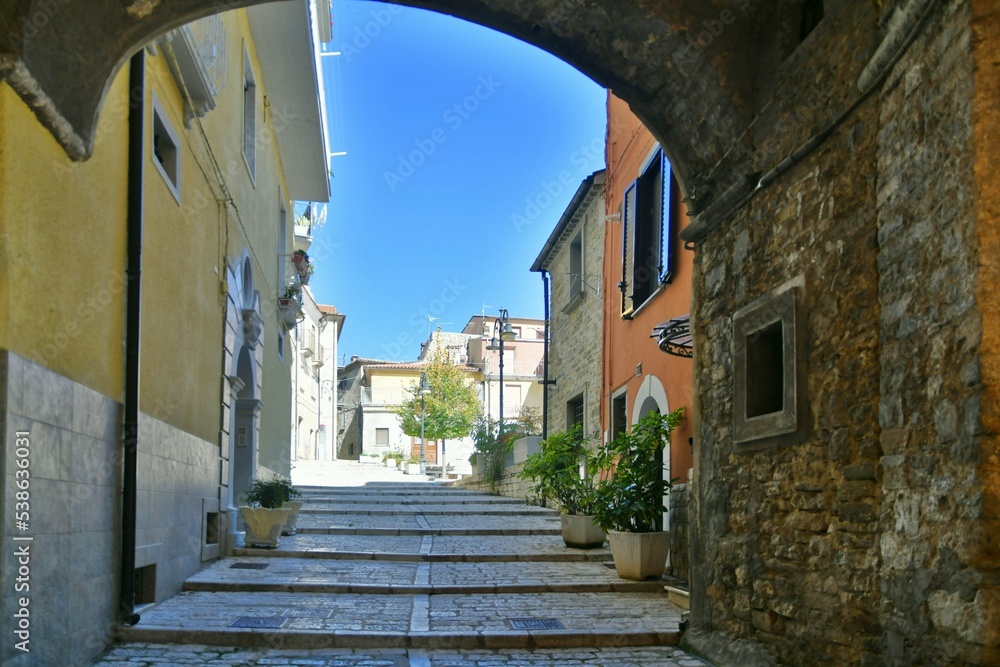 A narrow street between the old stone houses of Frosolone, a medieval village in the Molise region of Italy.