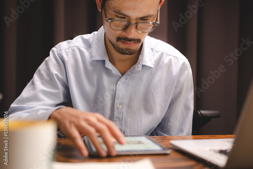 business communication technology concept, businessman person using digital pen to working on tablet computer screen device in modern office workplace, online marketing document on desk table