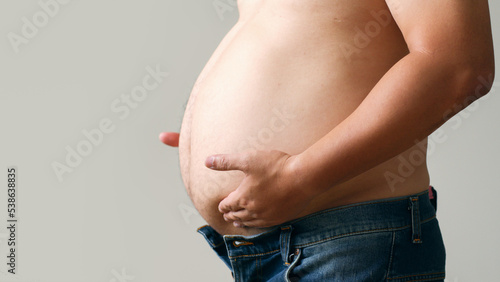 Close up big belly of fat asian man © Nattakorn