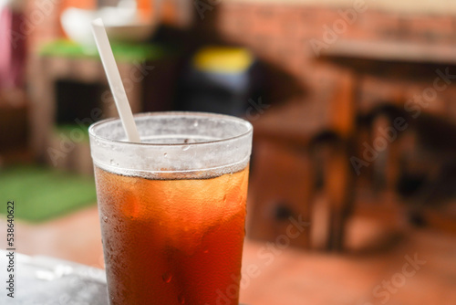 sweet cold iced tea in a transparent plastic cup