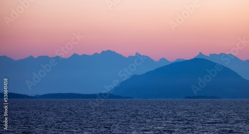 Colorful Sunrise on West Coast of Pacific Ocean with Islands and Canadian Mountain Landscape. Howe Sound near Vancouver, British Columbia, Canada. Nature Background