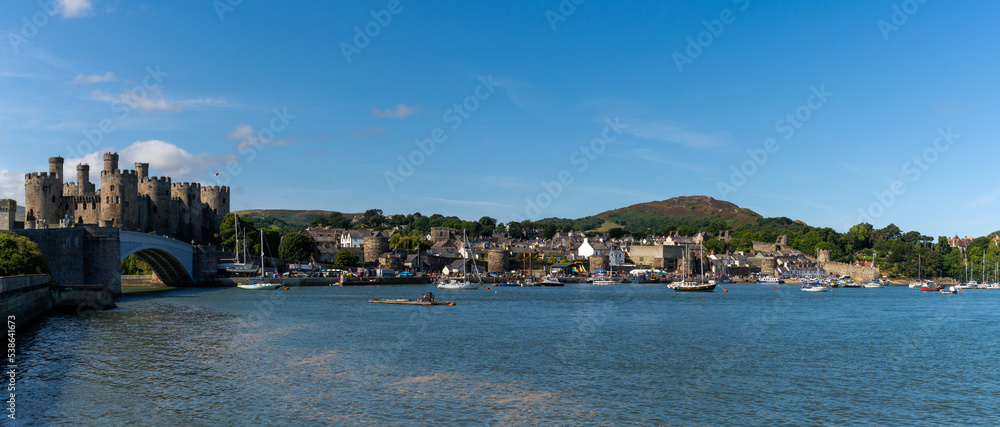panorama view of the Conwy Castle and bridge with the walled town and harbor behind