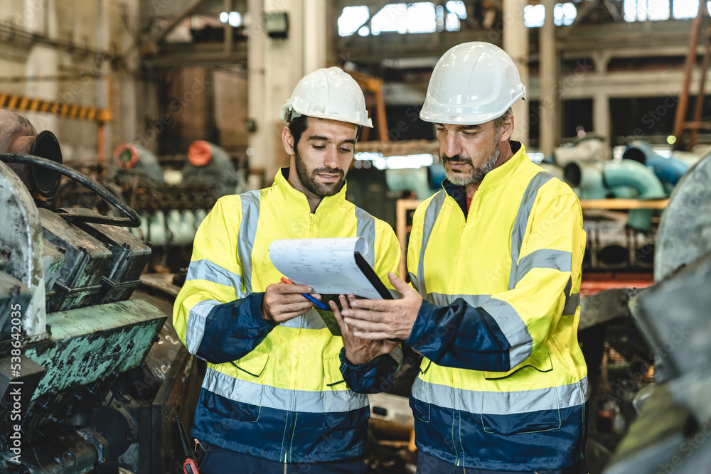 professional technician engineer working to check safety system of heavy industry manufacturing machine in construction plant and service a factory equipment of production job technology professional technician engineer working to check safety system of heavy industry manufacturing machine in construction plant and service a factory equipment of production job technology