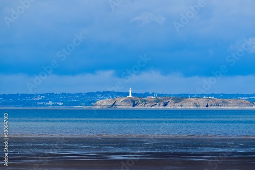 Seascape with a lighthouse on an island in the Bristol Channel, Weston-super-Mare, England, UK