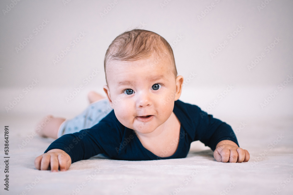 baby looks in frontal camera in crawling position baby looks in frontal camera in crawling position