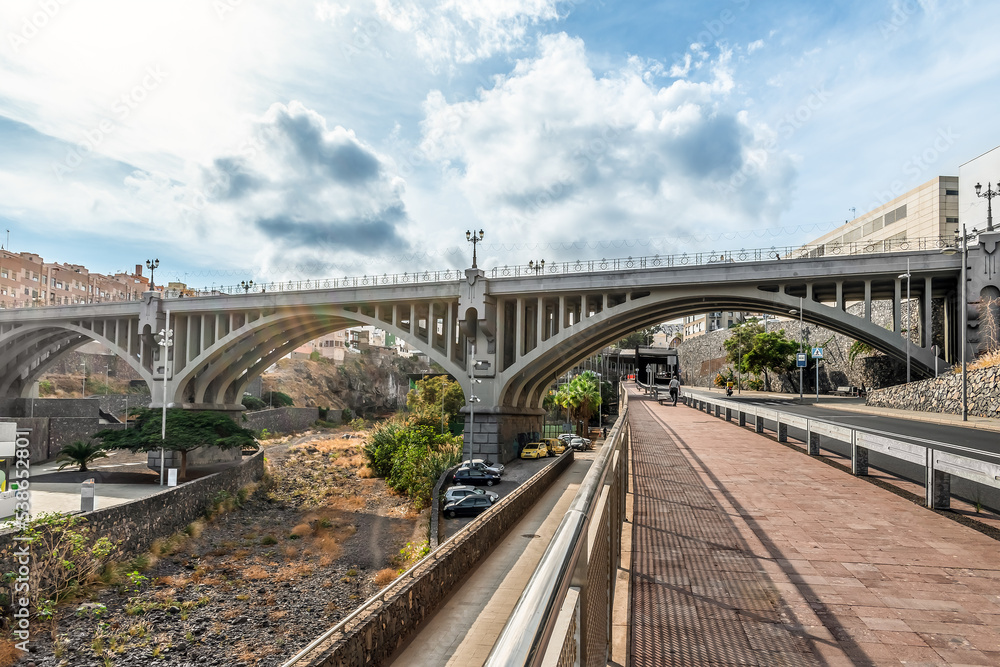 Naklejka premium Old arch Galceran Bridge over a dry riverbed Barranco de Santos in Santa Cruz de Tenerife, Spain. Road system in the capital of the Canary Islands