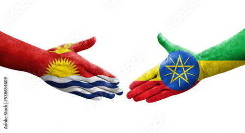 Handshake between Ethiopia and Kiribati flags painted on hands, isolated transparent image.