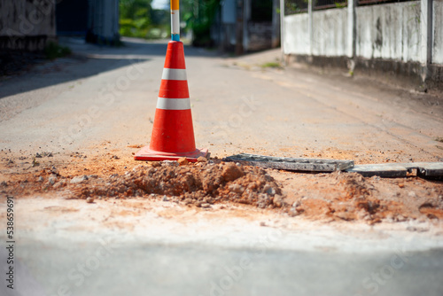 traffic cone on damaged road surface