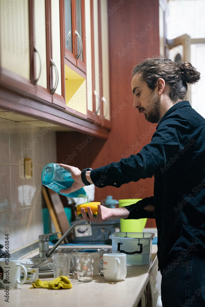 man washing dishes in the kitchen man washing dishes in the kitchen