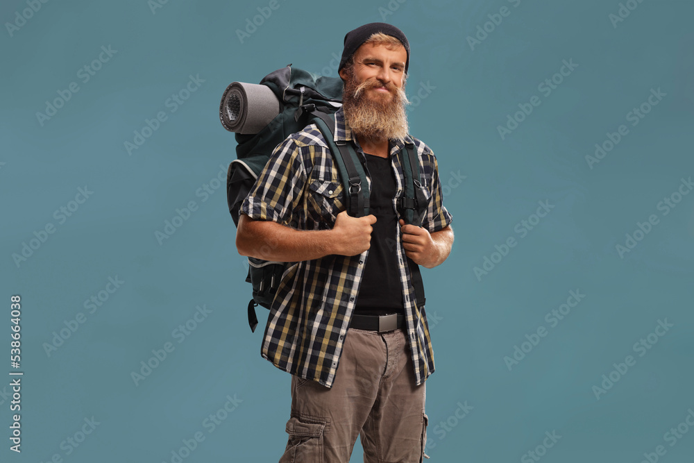 Fototapeta premium Smiling bearded hiker with a backpack posing