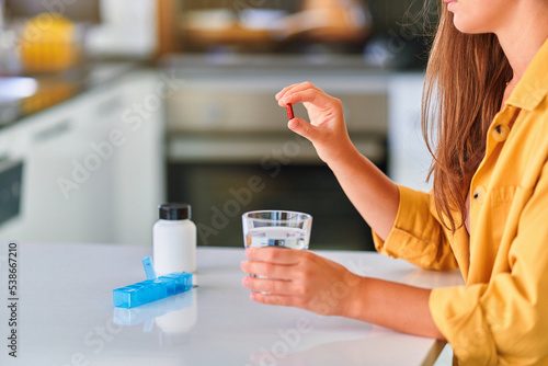 Person taking medicine at home