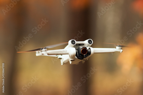 Drone in flight. Drone in the air on a beautiful autumn background
