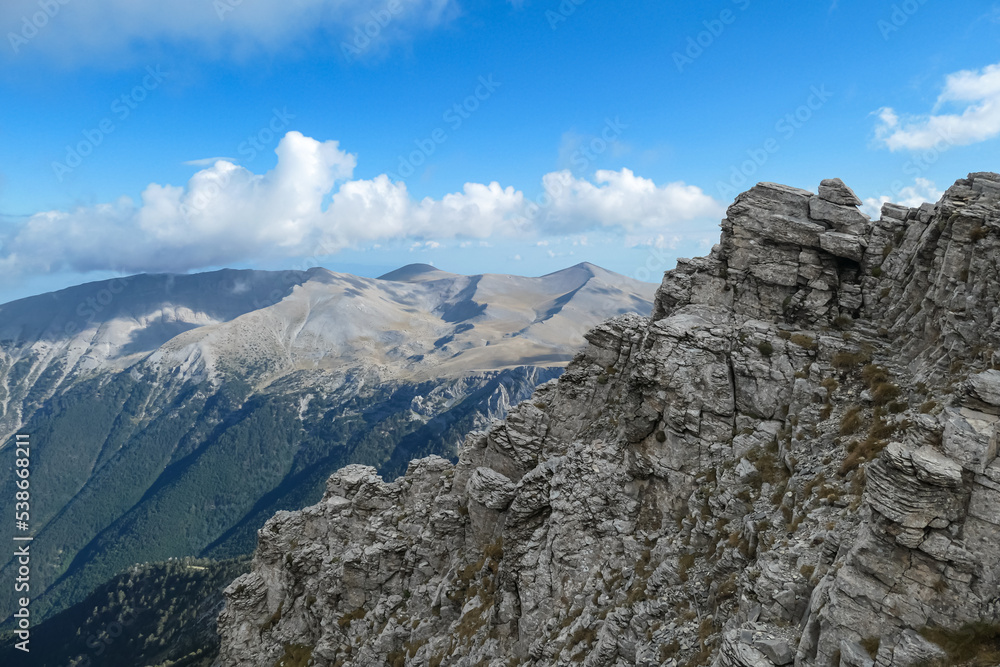 Panoramic view from cloud covered mountain summit of Mytikas Mount Olympus, Mt Olympus National Park, Macedonia, Greece, Europe. Home of the Ancient Greek gods. Hiking trail from Skala and Stefani