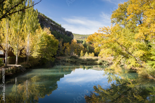  The Jucar river in autumn in Cuenca  Castilla La Mancha in Spain. Autumn landscape with trees full of yellow leaves