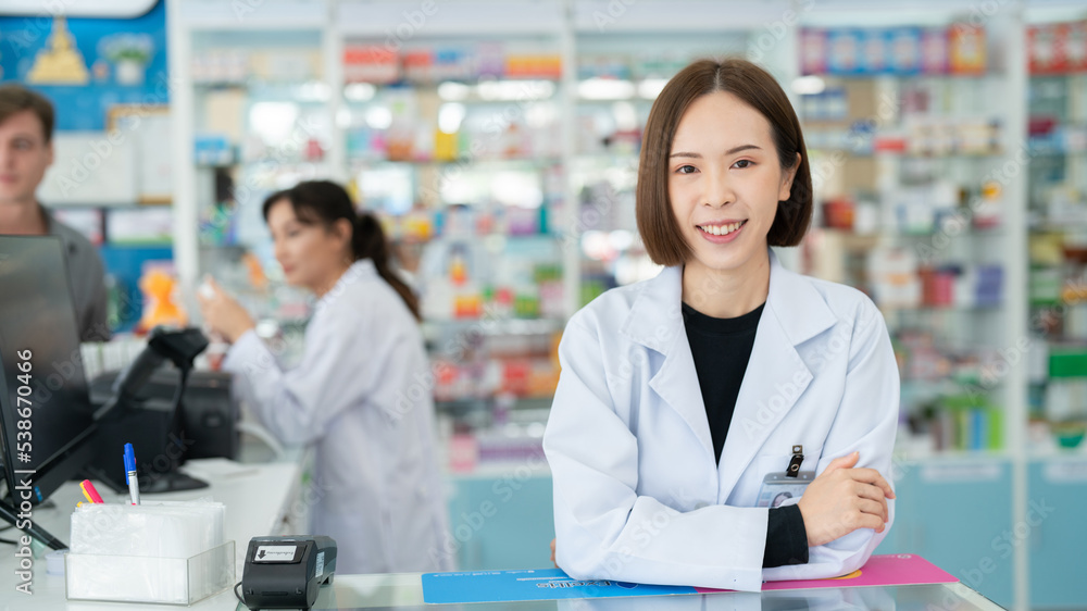 Pharmacy counters have pill products that take care of your health.Female pharmacist working at a pharmacy.An adult doctor smiling at a drugstore.