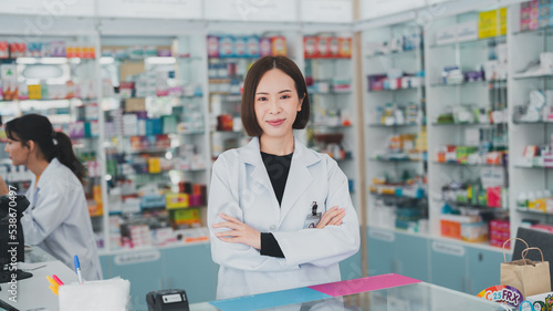 Free Download Pharmacy counters have pill products that take care of your health.Female pharmacist working at a pharmacy.An adult doctor smiling at a drugstore. - GFXLoad