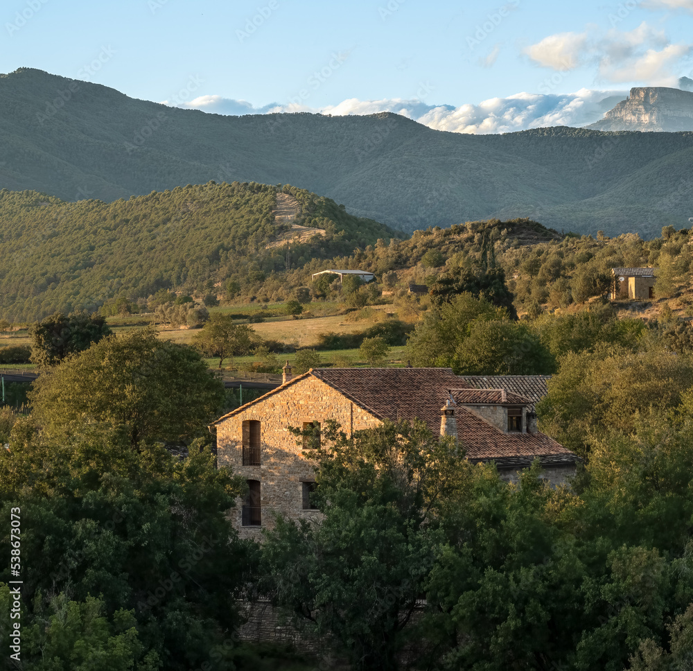 view over a traditional Spainsih dwelling in the Parque natural de la Sierra y los Cañones de Guara to the Spanish Pyrenees mountains