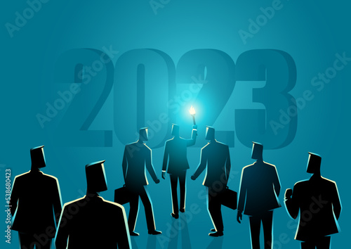 Businessman with torch leading other businessmen behind him into the year 2023