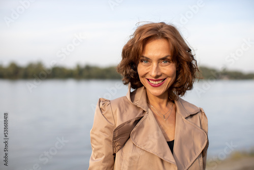 woman enjoying a beautiful autumn day by the river