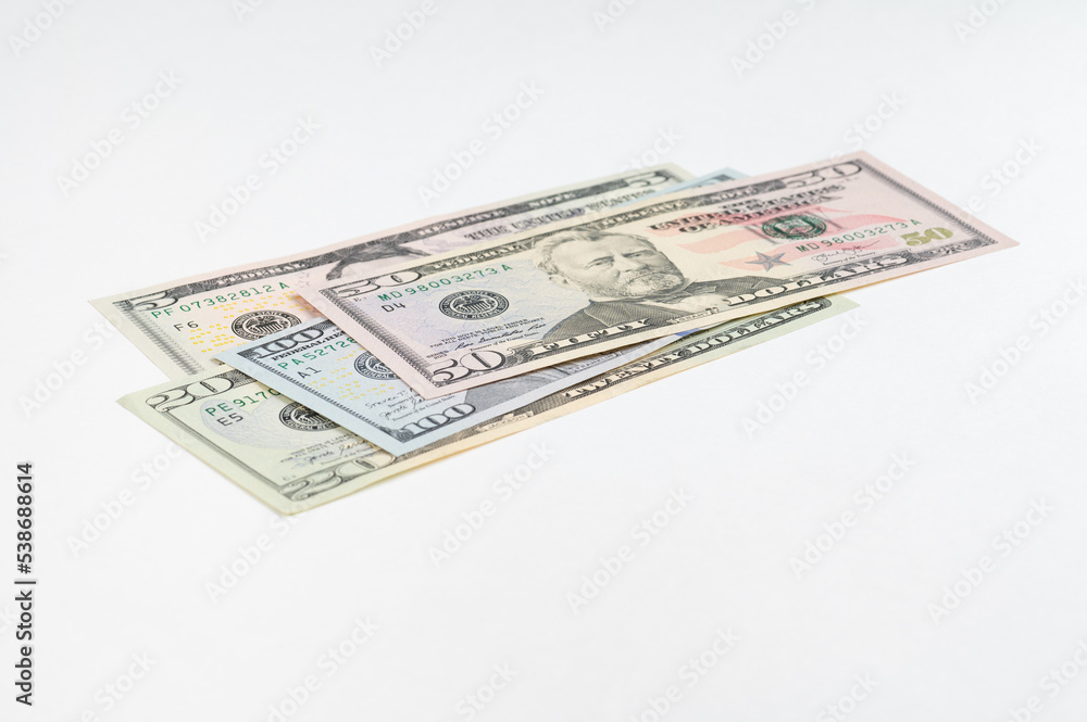 5, 20, 50, 100 dollars banknotes at different angles. Close up of dollars on white background. 5, 20, 50, 100 dollars banknotes at different angles. Close up of dollars on white background.