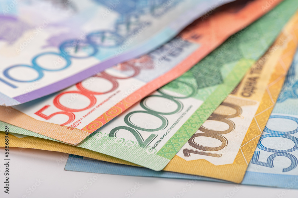 Kazakhstan money - tenge. 500, 1000, 2000, 5000, 10000 banknotes. Close up of tenge on white background. Kazakhstan money - tenge. 500, 1000, 2000, 5000, 10000 banknotes. Close up of tenge on white background.