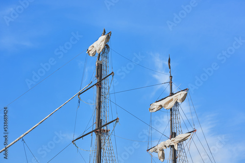 Fotografie View of the masts, sails and tackle of a wooden sailboat - ropes, shrouds, rope ladders